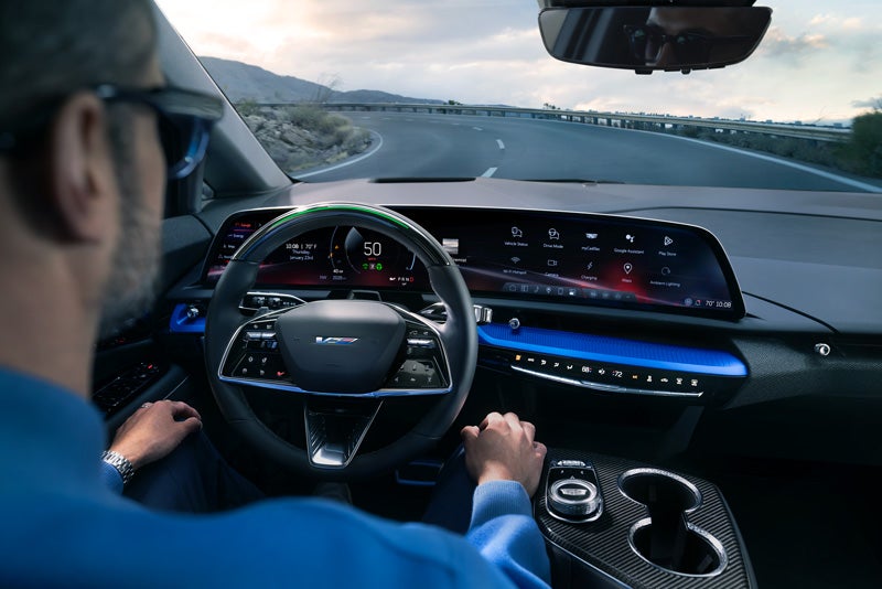 Front View of the 2026 OPTIQ-V Driving Through the Dusk Utilizing its Headlights | Titus-Will Cadillac in Olympia WA